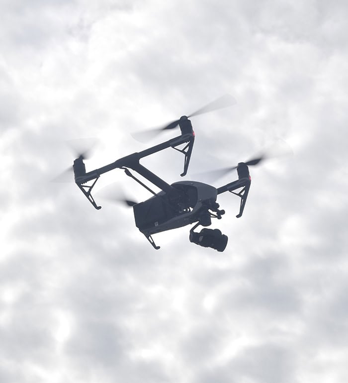 A Seismic Surveys drone flying in the air, performing a post-construction survey.